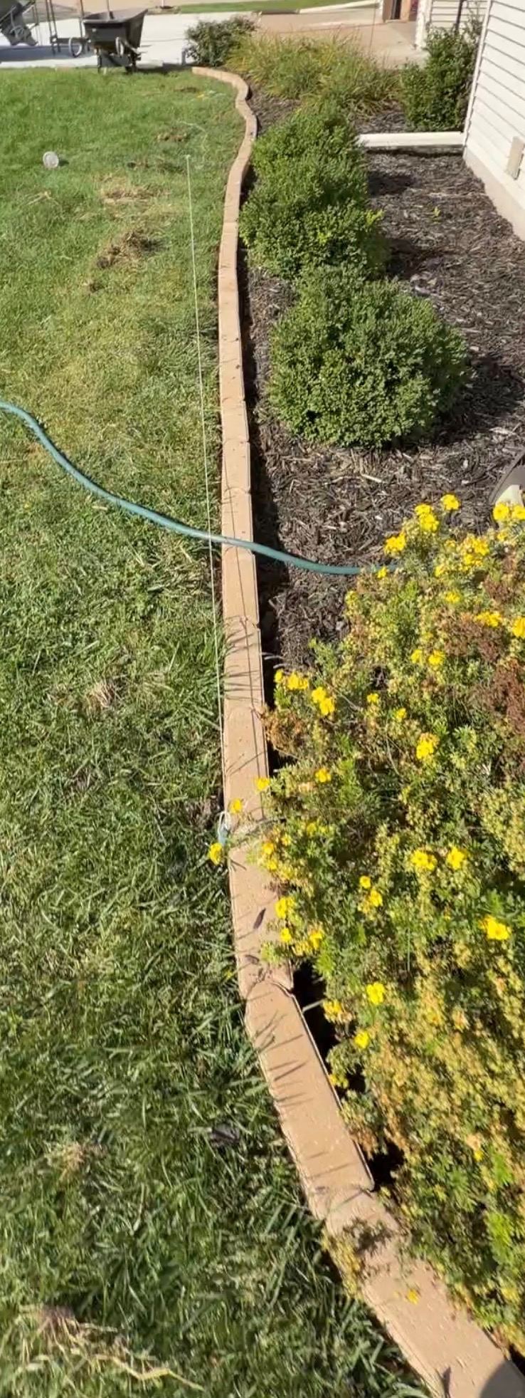 Bushes trimmed and a clean new border edge installed along the bed